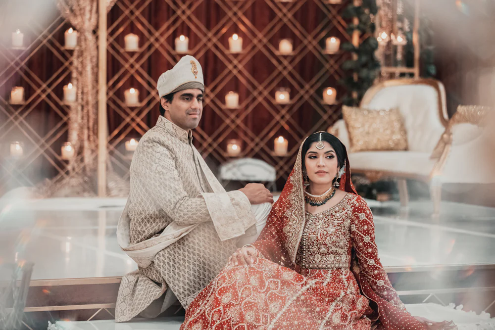 A South Asian bride and groom seated together at their wedding